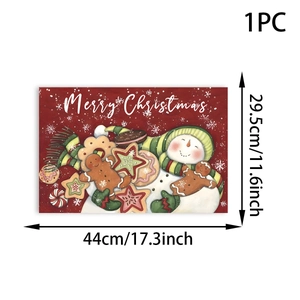 Detailed view of red Christmas placemat with snowman and gingerbread man patterns