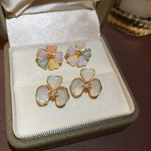 Close-up of colorful floral earrings with 18k gold plating in a velvet jewelry box