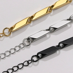 Macro detail of geometric titanium steel bar chains in gold, silver and black finishes