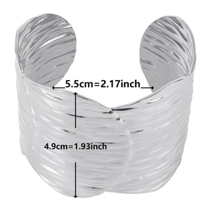 Macro view of silver wavy textured wide cuff bracelet with detailed size measurements
