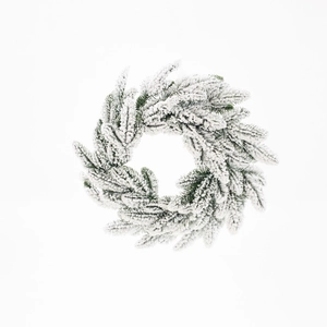 Artificial Christmas wreath with realistic green pine needles and dense snow flocking