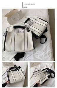 Detail view of contrast stitch canvas tote bag with black strap and top handle design