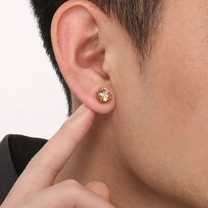Detail of champagne zircon magnetic earring in rose gold finish on a model ear