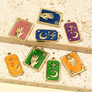 French vintage celestial star and moon enamel pendants on textured stone slabs