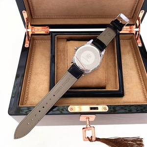 Detailed back view of stainless steel quartz watch with genuine leather strap in a wood box