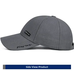 Detail of dark grey baseball cap showing DING HAN woven label and embroidered brim detail