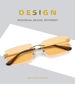Detail of rimless square sunglasses with orange lenses and gold metal temples