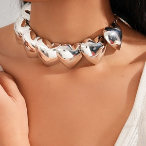 Close-up of polished silver heart pendants on a metallic choker necklace for women