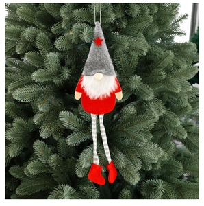 Close-up of a grey and red Christmas gnome ornament hanging on a green festive tree