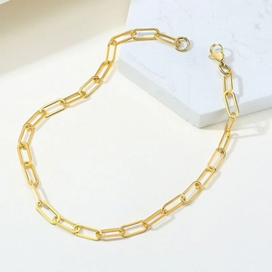 Detailed macro view of the gold paperclip link chain with a polished spring clasp finish