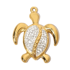 Detailed view of a gold turtle pendant with sparkling rhinestones and a polished finish