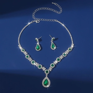 Detailed close-up of emerald green teardrop crystal necklace and earrings set