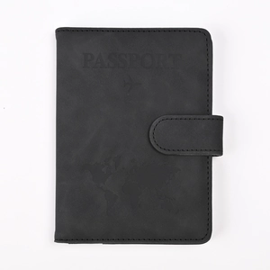 Close-up of black RFID PU leather passport cover with world map and airplane embossing