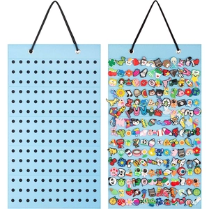Blue felt wall-mounted organizer for display and storage of 180 shoe charms and pins