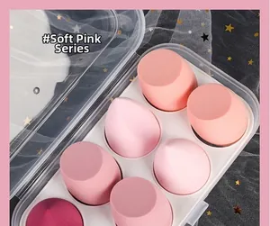 Eight-piece pink gradient makeup sponge set with various shapes in a clear storage box