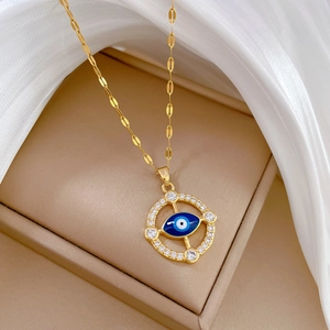 Luxurious gold titanium steel necklace featuring a dazzling diamond-encrusted evil eye pendant