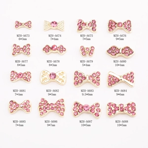16 styles of golden nail art charms with pink rhinestones for festive manicure designs