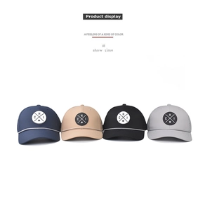Flat lay view of four breathable mesh trucker hats in navy, beige, black, and grey colors
