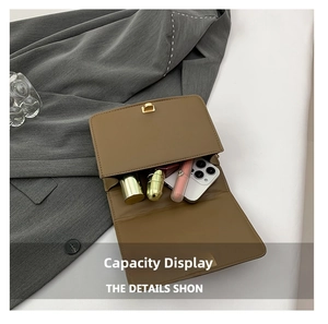 Internal capacity of brown leather crossbody bag showing phone and lipstick storage