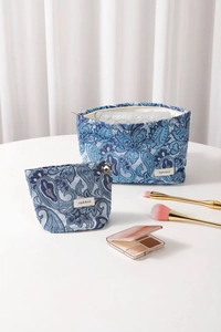 Close-up of a two-piece blue paisley jacquard cosmetic bag set with golden zipper