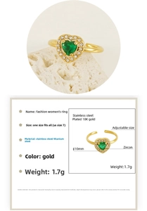 Detail of 18K gold-plated ring featuring heart-shaped green zircon and adjustable band