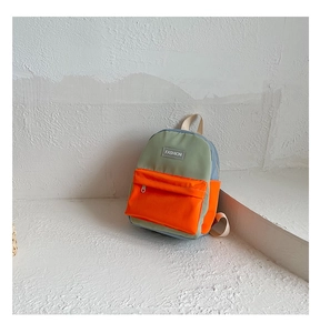 Detail view of mini canvas backpack featuring a grey-green and orange color-block design