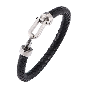 Detailed view of the black braided leather bracelet with a silver horseshoe metal buckle