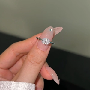Close-up of S925 silver ring with teardrop zircon on model hand for a luxury wedding style