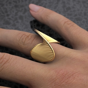 Detailed macro view of 18k gold stainless steel ring with twisted stripe texture