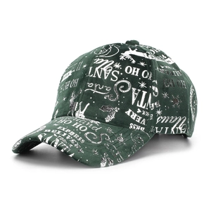 Detail of dark green Christmas baseball cap featuring white festive patterns and phrases