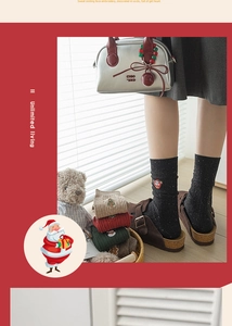 Close-up of Christmas cotton socks with embroidery of Santa and trees in a cozy setting