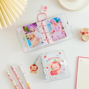 Macro detail of transparent PVC 3-hole mini photo albums with cute cartoon bear motifs