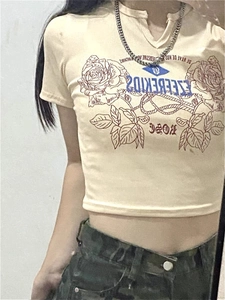 Close-up of beige cotton T-shirt featuring red rose graphic and blue mirror text design