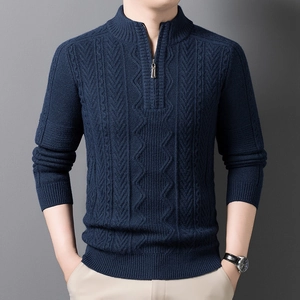 Detail of navy blue half-zip knit sweater showing ribbed cuffs and vertical texture