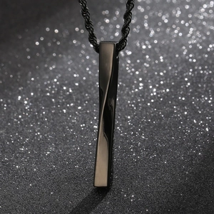Macro shot of black stainless steel twisted bar pendant on a matching rope chain necklace