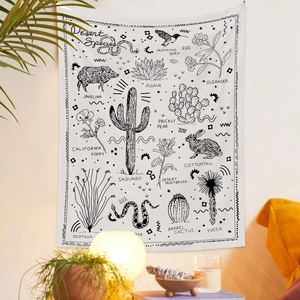 Detail of desert species wall tapestry featuring cacti and wildlife line art design