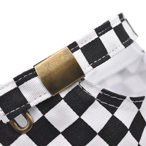 Detail view of cotton checkerboard baseball cap with adjustable brass metal buckle