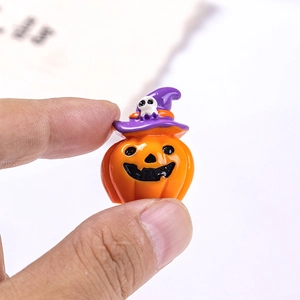 Detailed view of a miniature Halloween pumpkin figurine featuring a purple wizard hat and skull