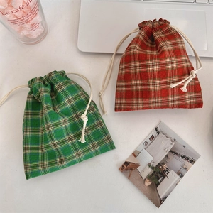 Detail of red and green plaid cotton drawstring storage bags for cosmetics and jewelry