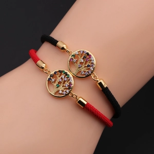 Detail showing Life of Tree charm with multi-color zircons on braided bracelets