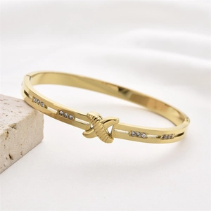 Elegant gold titanium steel cuff bracelet with sparkling X-shape crystal inlay details