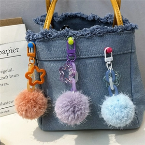 Colorful plush flower keychain with star hook on denim bag for fashion accessory