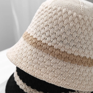 Detailed macro view of breathable crochet knit texture and stripe patterns on bucket hats