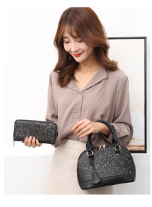 Detail of sequin shell handbag and matching wallet set with elegant gold hardware accents