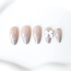 Cat eye ombre press-on nails with 3D white bows and rhinestones in almond shape