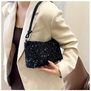 Detail of black sequin shoulder bag with leather strap and unique knotted decoration