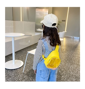 Detail of yellow PVC child chest bag with sparkling colorful sequins in transparent window