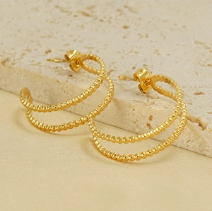 Detail of 18K gold plated double layer beaded hoop earrings on a stone display