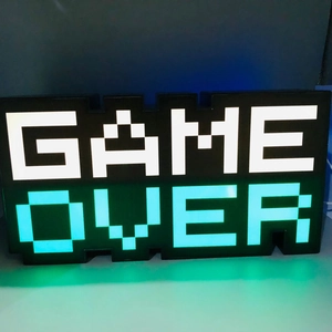 Pixel art GAME OVER LED sign featuring white and cyan glowing lights in dark setting