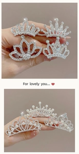Close-up of sparkling silver hair crowns with crystals and pearls for kids